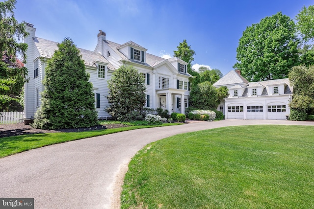 view of front of property with a front yard and a garage