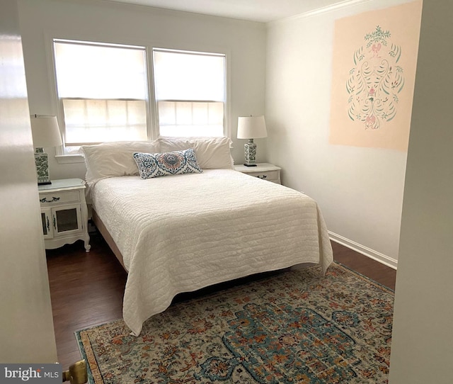 bedroom with dark hardwood / wood-style flooring and multiple windows