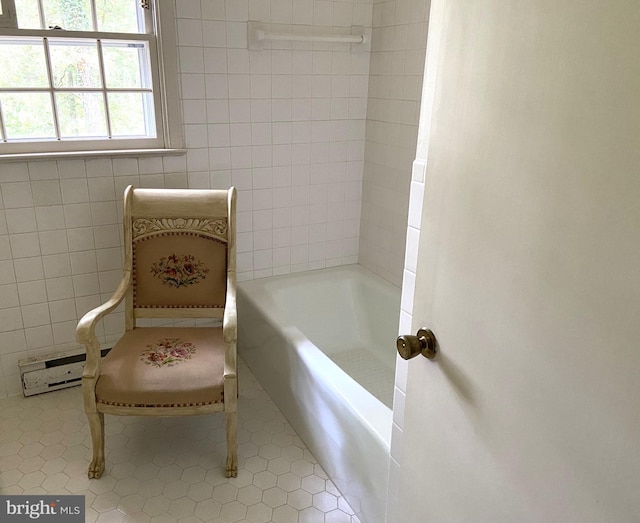 bathroom with tile patterned floors and tile walls