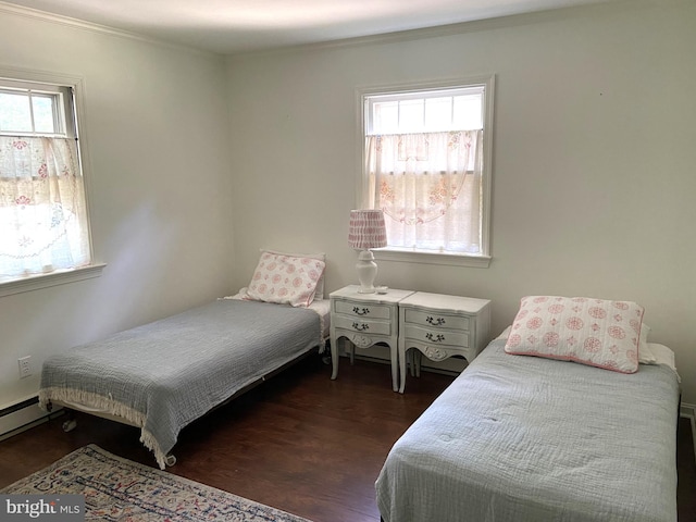 bedroom featuring crown molding, wood-type flooring, and multiple windows