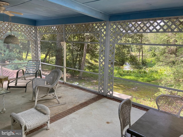 sunroom / solarium featuring ceiling fan