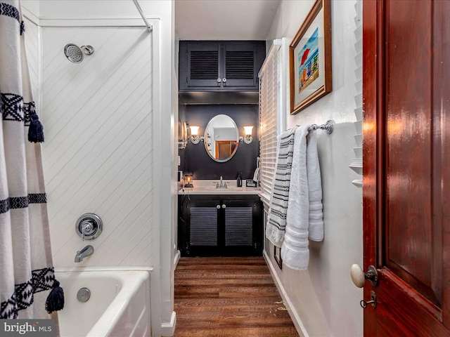 bathroom featuring hardwood / wood-style floors, vanity, and shower / tub combo with curtain