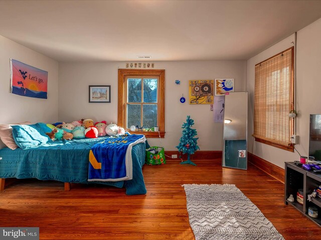 bedroom featuring ceiling fan and dark hardwood / wood-style flooring