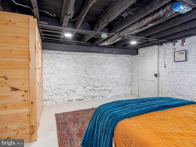 bedroom featuring concrete flooring