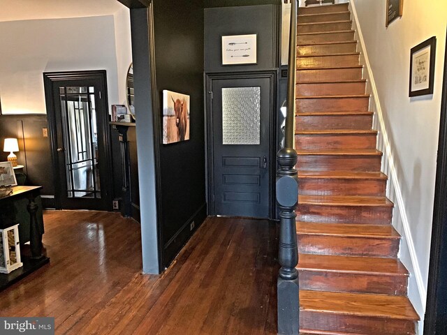 staircase featuring hardwood / wood-style flooring