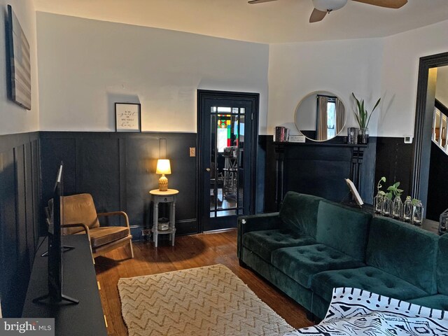 kitchen with sink, stainless steel appliances, wall chimney range hood, and light wood-type flooring