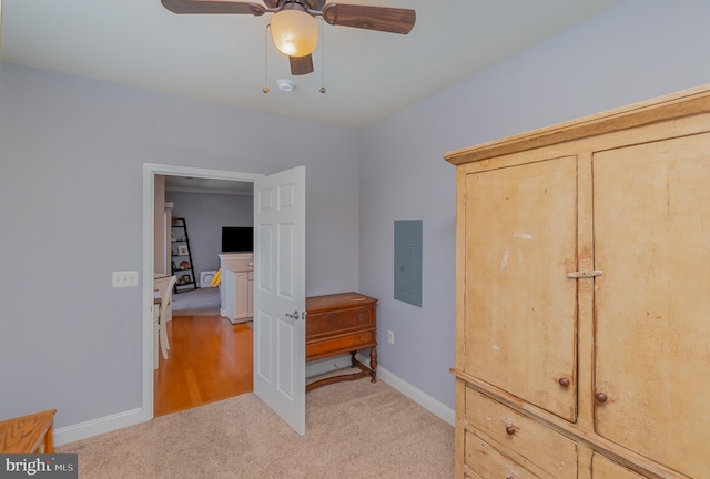 carpeted bedroom featuring ceiling fan and electric panel