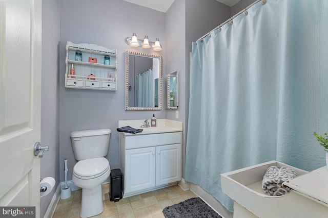 bathroom featuring toilet and vanity