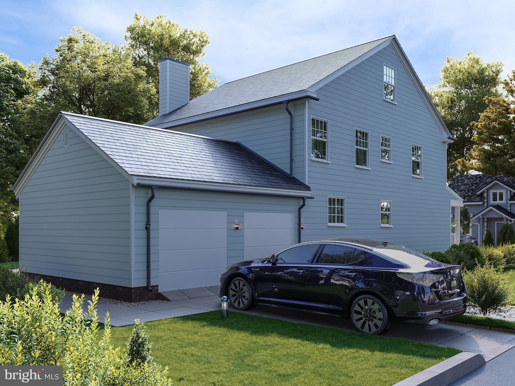 view of side of property with a garage and a yard