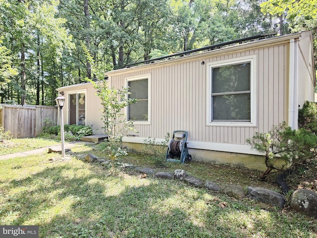 view of side of property featuring a yard