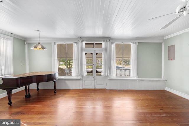 misc room with ceiling fan, ornamental molding, plenty of natural light, and wood-type flooring