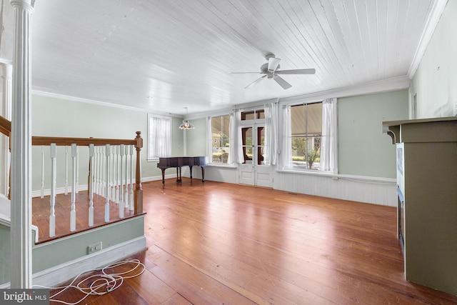 interior space with hardwood / wood-style flooring, ceiling fan, and ornamental molding