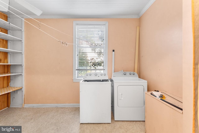 laundry area with crown molding and washer and clothes dryer