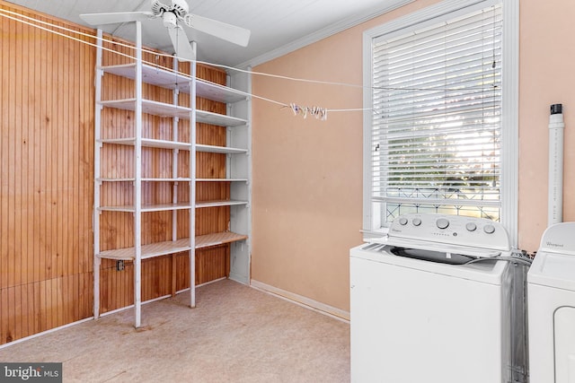 clothes washing area featuring ceiling fan, ornamental molding, and washing machine and clothes dryer