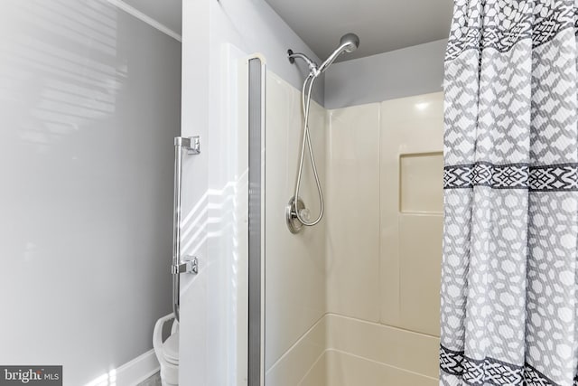 bathroom featuring toilet and walk in shower