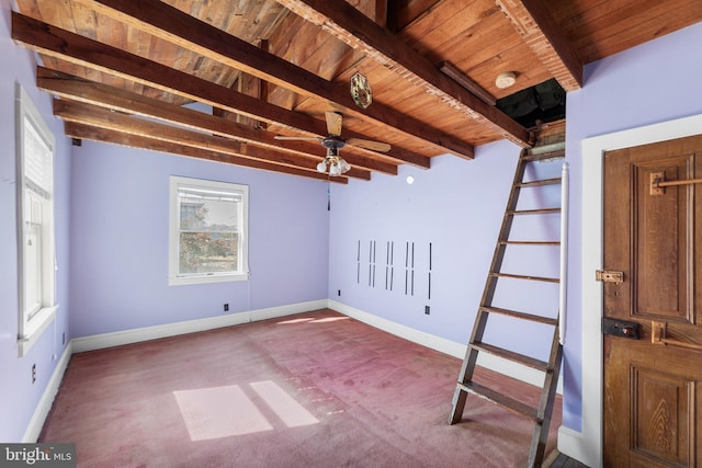 unfurnished room with beam ceiling and wooden ceiling