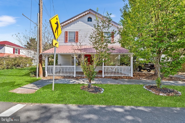 farmhouse-style home with a porch and a front yard