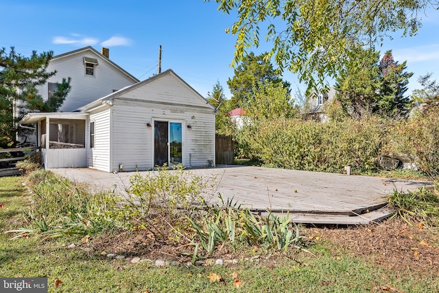 back of property with a sunroom