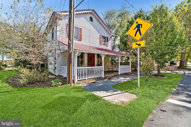 view of front of house with a front lawn and covered porch