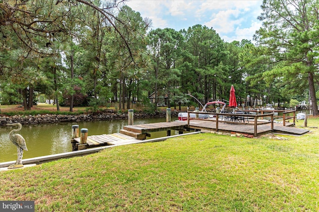 dock area featuring a lawn and a water view