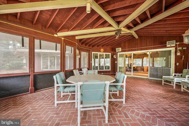 unfurnished sunroom featuring vaulted ceiling and a wealth of natural light