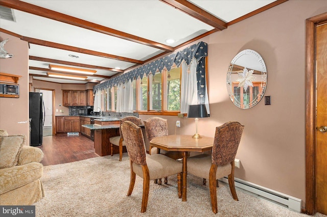 dining room featuring beam ceiling, dark wood-style flooring, a baseboard radiator, and visible vents