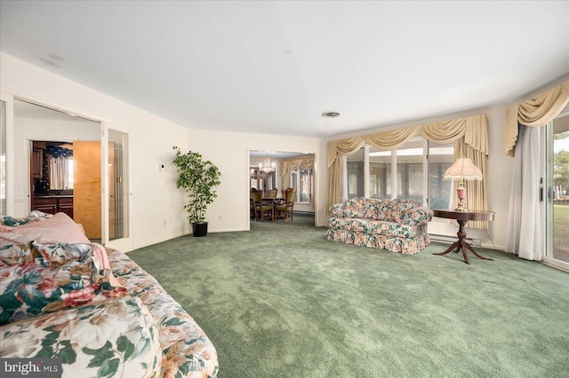 carpeted bedroom with a walk in closet, visible vents, and access to exterior