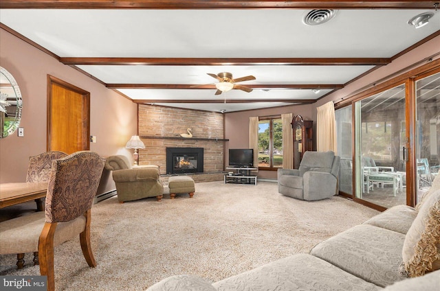 living room featuring visible vents, ceiling fan, beamed ceiling, carpet, and a stone fireplace