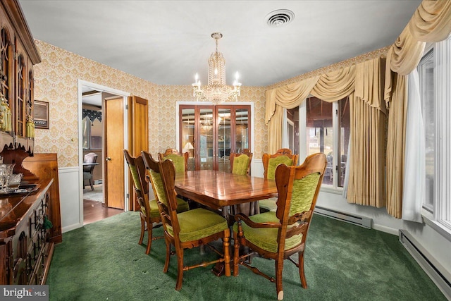 dining space with wallpapered walls, visible vents, a wainscoted wall, a baseboard radiator, and an inviting chandelier