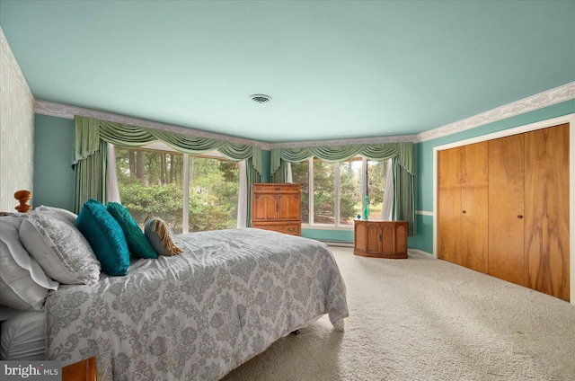 carpeted bedroom with a closet and visible vents