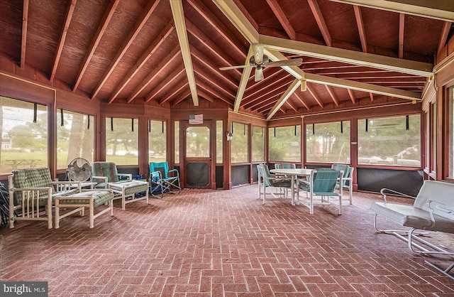 unfurnished sunroom featuring a ceiling fan and lofted ceiling