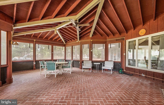 unfurnished sunroom featuring ceiling fan and vaulted ceiling