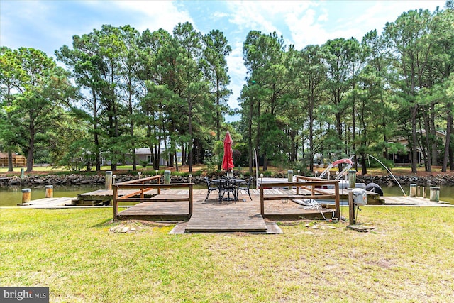 view of jungle gym with a lawn and a deck with water view