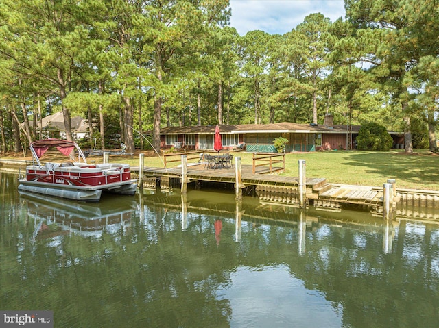 dock area with a yard and a water view