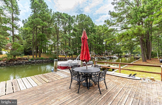 wooden deck featuring a water view and a boat dock