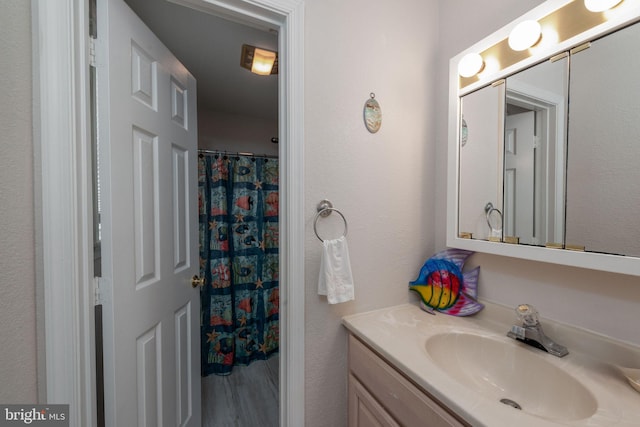 bathroom featuring vanity and a shower with shower curtain