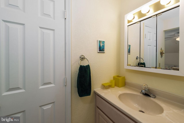 bathroom featuring ceiling fan and vanity