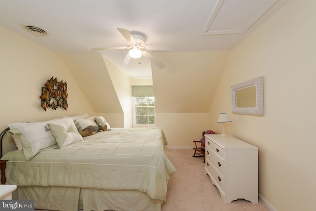 carpeted bedroom with ceiling fan and vaulted ceiling