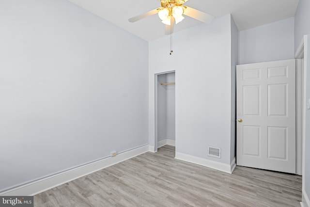 unfurnished bedroom featuring light wood-style flooring, a closet, visible vents, and baseboards