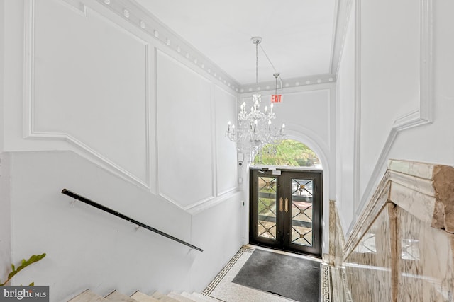 entryway featuring a chandelier and french doors