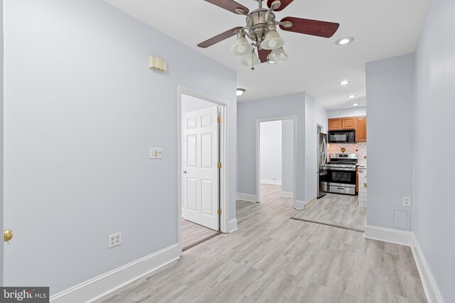 unfurnished living room featuring recessed lighting, light wood-style flooring, and baseboards