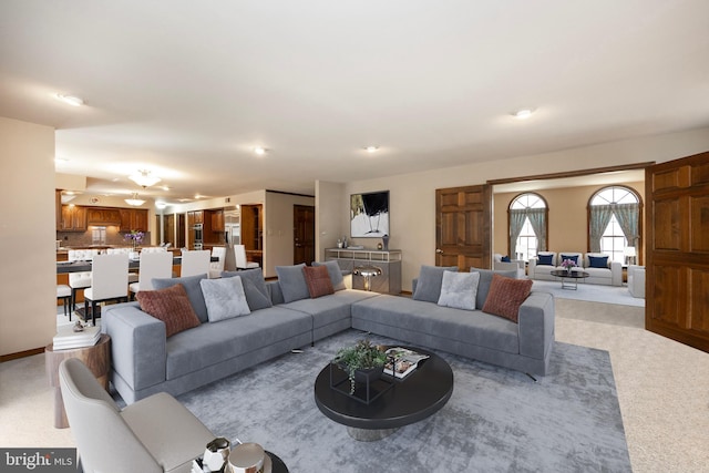 living room with light colored carpet and baseboards