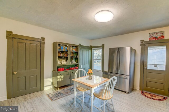 dining space with light hardwood / wood-style flooring