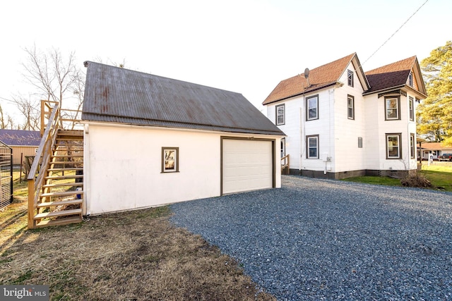 view of side of home with an outdoor structure and a garage