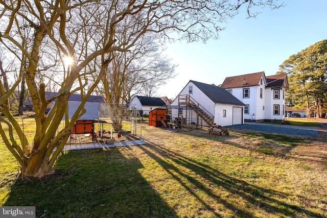 view of yard featuring a wooden deck and an outbuilding