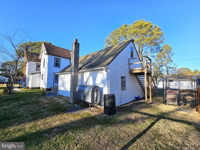 back of house with a lawn