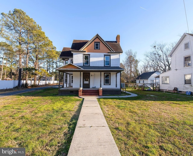 view of front of property with covered porch and a front yard