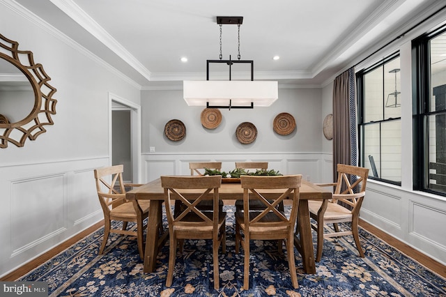 dining space with ornamental molding and dark hardwood / wood-style floors