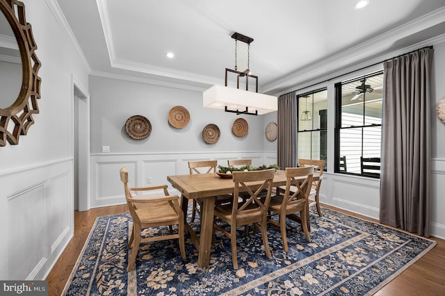 dining area featuring ornamental molding and dark hardwood / wood-style floors