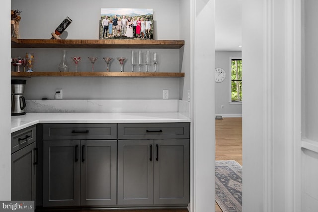 bar featuring gray cabinets and hardwood / wood-style floors